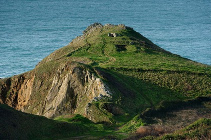 Cette baie bien abritée est une plage de galets et de sable fin, et tire son nom des moulins qui existaient autrefois dans la vallée qui la surplombe (écailler le grain). Les roches de l'anse de Cul Rond figurent parmi les plus anciennes de France : plus de 2 milliards d'années.