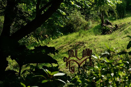 En hommage au poète, ses amis dont Gérard Fusberti, propriétaire du terrain et gardien du temple, décident de créer un jardin où chacun plantera son arbre ou laissera une de ses créations. Montand, Reggiani, Greco ou Mouloudji plantèrent chacun leur double végétal lors de la célébration du dixième anniversaire de la mort de Prévert, un eucalyptus aujourd'hui haut d'au moins 20 mètres pour Mouloudji.Se balader dans ce jardin, c'est pénétrer dans l'univers du poète. Au milieu des arbres d'ornement, des bambous peints de rouge vif, des arbres fruitiers, des camélias, des azalées, des gunneras (que Prévert adorait) et des hortensias, des œuvres d'art se révèlent ça et là, tantôt un portrait, tantôt une sculpture ou une installation. Des arbres peints prennent vie, une main rouge semblant sortir de leur entrailles, le ruisseau qui coule en cascade murmure une douce poésie, que l'on retrouve en quelques phrases inscrites sur des plaques qui surgissent au milieu de cette jungle organisée. (Saint-Germain-des-Vaux Manche)