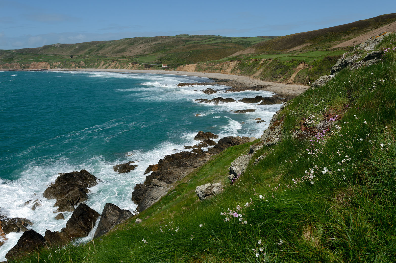 Cette baie bien abritée est une plage de galets et de sable fin, et tire son nom des moulins qui existaient autrefois dans la vallée qui la surplombe (écailler le grain). Les roches de l'anse de Cul Rond figurent parmi les plus anciennes de France : plus de 2 milliards d'années.